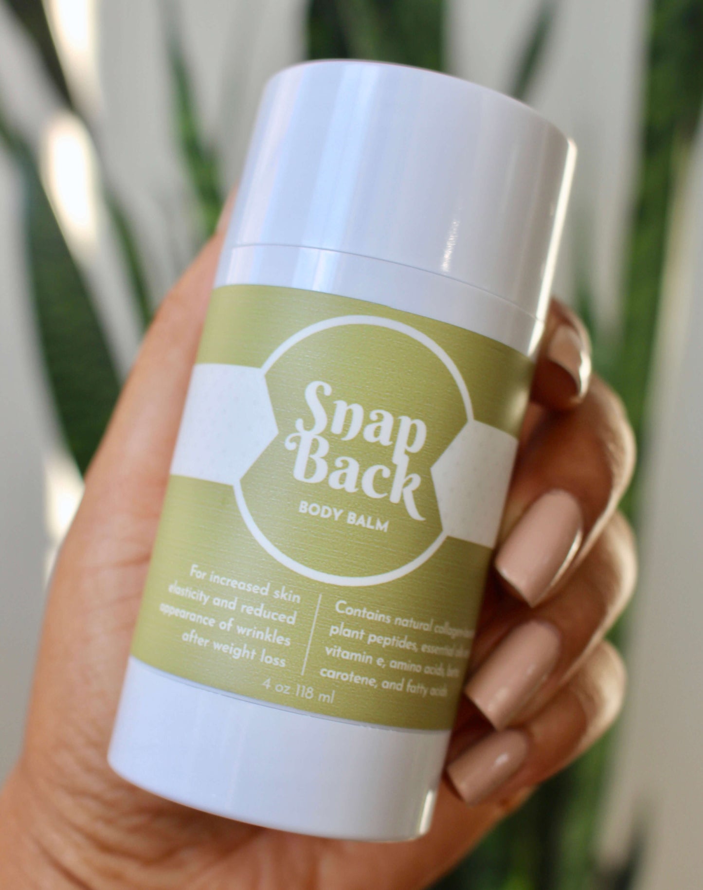 Woman holding snap back body balm