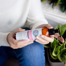 Load image into Gallery viewer, Woman holding curl ease styling lotion for naturally curly hair